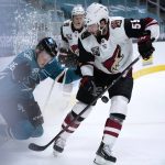 San Jose Sharks right wing Joachim Blichfeld (86) is checked against the boards by Arizona Coyotes defenseman Jason Demers (55) during the third period of an NHL hockey game Wednesday, April 28, 2021, in San Jose, Calif. San Jose won 4-2. (AP Photo/Tony Avelar)