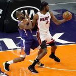 Miami Heat forward Trevor Ariza (8) backs down on Phoenix Suns guard Chris Paulduring the first half of an NBA basketball game, Tuesday, April 13, 2021, in Phoenix. (AP Photo/Matt York)