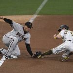 San Diego Padres' Jake Cronenworth is tagged out by Arizona Diamondbacks third baseman Asdrubal Cabrera on an attempted steal during the fourth inning of a baseball game Friday, April 2, 2021, in San Diego. (AP Photo/Denis Poroy)