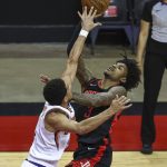 Houston Rockets guard Kevin Porter Jr. (3) shoots the ball against Phoenix Suns guard Devin Booker (1) during the first quarter of an NBA basketball game in Houston, Monday, April 5, 2021. (Troy Taormina/Pool Photo via AP)