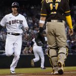 Arizona Diamondbacks' Nick Ahmed (13) scores on a triple hit by Nick Heath during the second inning of a baseball game against the San Diego Padres, Tuesday, April 27, 2021, in Phoenix. (AP Photo/Matt York)