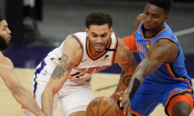 Phoenix Suns forward Abdel Nader (11) battles Oklahoma City Thunder guard Hamidou Diallo for the ba...