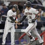 
              Arizona Diamondbacks' Carson Kelly, right, is congratulated by third base coach Tony Perezchica after hitting a two-run home run against the Atlanta Braves in the fifth inning of a baseball game Friday, April 23, 2021, in Atlanta. (AP Photo/Ben Margot)
            