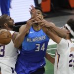 Milwaukee Bucks Giannis Antetokounmpo, center, loses control of the ball between Phoenix Suns' Chris Paul, left, and Cameron Johnson, right, during the second half of an NBA basketball game Monday, April 19, 2021, in Milwaukee. (AP Photo/Aaron Gash)