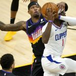 Los Angeles Clippers guard Reggie Jackson (1) drives as Phoenix Suns forward Torrey Craig defends during the second half of an NBA basketball game, Wednesday, April 28, 2021, in Phoenix. (AP Photo/Matt York)