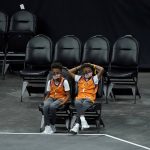 A pair of Phoenix Suns fans watch during the first half of an NBA basketball game against the Sacramento Kings, Thursday, April 15, 2021, in Phoenix.(AP Photo/Matt York)