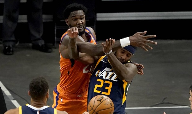 Phoenix Suns center Deandre Ayton knocks the ball away from Utah Jazz forward Royce O'Neale (23) du...