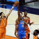 Oklahoma City Thunder guard Theo Maledon (11) drives to the basket past Phoenix Suns guard Devin Booker (1) during the first half of an NBA basketball game Friday, April 2, 2021, in Phoenix. (AP Photo/Rick Scuteri)