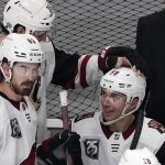 Arizona Coyotes left wing Michael Bunting, right, celebrates with teammate right wing Christian Fischer, center, after his third goal of the game was confirmed in a video review as right wing Conor Garland looks on during the second period of an NHL hockey game against the Los Angeles Kings Monday, April 5, 2021, in Los Angeles. (AP Photo/Mark J. Terrill)