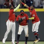 Atlanta Braves outfielders, from left to right, Marcell Ozuna, Guillermo Heredia and Ronald Acuna Jr. celebrate their win over the Arizona Diamondbacks at the end of a baseball game Friday, April 23, 2021, in Atlanta. (AP Photo/Ben Margot)
