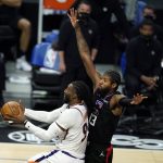 Phoenix Suns forward Jae Crowder, left, drives past Los Angeles Clippers guard Paul George during the first half of an NBA basketball game Thursday, April 8, 2021, in Los Angeles. (AP Photo/Marcio Jose Sanchez)