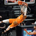 Phoenix Suns guard Jevon Carter (4) dunks over Oklahoma City Thunder guard Ty Jerome during the first half of an NBA basketball game Friday, April 2, 2021, in Phoenix. (AP Photo/Rick Scuteri)