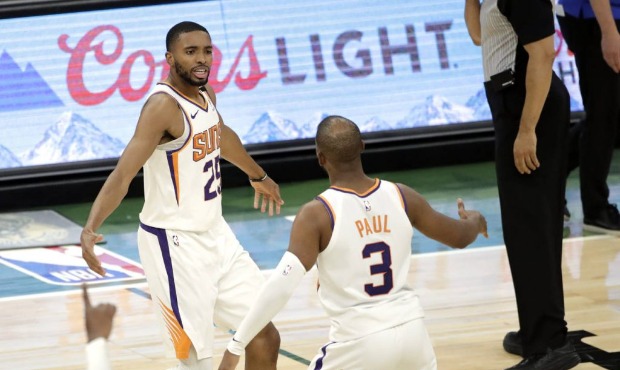 Phoenix Suns' Mikal Bridges, left, is congratulated by Chris Paul, right, during overtime of an NBA...