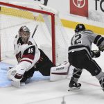 Arizona Coyotes goalie Darcy Kuemper (35) defends against Los Angeles Kings left wing Trevor Moore (12) during the second period of an NHL hockey game Saturday, April 24, 2021, in Los Angeles. (AP Photo/Michael Owen Baker)