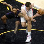 Phoenix Suns guard Cameron Payne reaches for the ball as Los Angeles Clippers center Ivica Zubac, right, gains control during the first half of an NBA basketball game, Wednesday, April 28, 2021, in Phoenix. (AP Photo/Matt York)