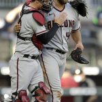 Arizona Diamondbacks pitcher Madison Bumgarner, right, is congratulated by catcher Carson Kelly after pitching a seven-inning no-hitter against the Atlanta Braves, at the end of the second baseball game of a doubleheader, Sunday, April 25, 2021, in Atlanta. (AP Photo/Ben Margot)