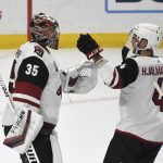 Arizona Coyotes goalie Darcy Kuemper (35) is congratulated by defenseman Niklas Hjalmarsson (4) after the team's 4-0 win over the Los Angeles Kings in an NHL hockey game Saturday, April 24, 2021, in Los Angeles. (AP Photo/Michael Owen Baker)