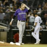 After getting stranded on third base against the Arizona Diamondbacks, Colorado Rockies' Trevor Story walks back to the dugout during the sixth inning of a baseball game Friday, April 30, 2021, in Phoenix. (AP Photo/Darryl Webb)