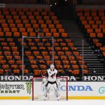 
              FILE - Arizona Coyotes goaltender Adin Hill guards his net with empty seats behind him during the first period of an NHL hockey game against the Anaheim Ducks in Anaheim, Calif., in this Friday, April 2, 2021, file photo. While the NFL, NBA and Major League Baseball are moving to relax virus protocols when a vast majority of a team’s players, coaches and staff are vaccinated, the NHL finds itself in an uncomfortable position. (AP Photo/Jae C. Hong, File)
            