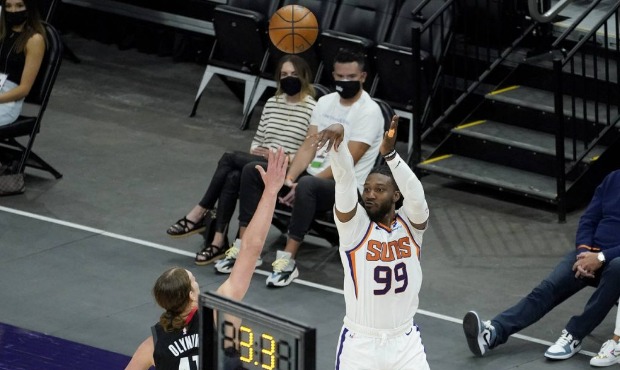 Phoenix Suns forward Jae Crowder (99) shoots a three pointer over Houston Rockets forward Kelly Oly...