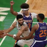 Boston Celtics forward Jayson Tatum (0) looks for room to pass the ball against the defense of Phoenix Suns forwards Mikal Bridges (25) and Cameron Johnson (23) in the second half of an NBA basketball game, Thursday, April 22, 2021, in Boston. (AP Photo/Elise Amendola)