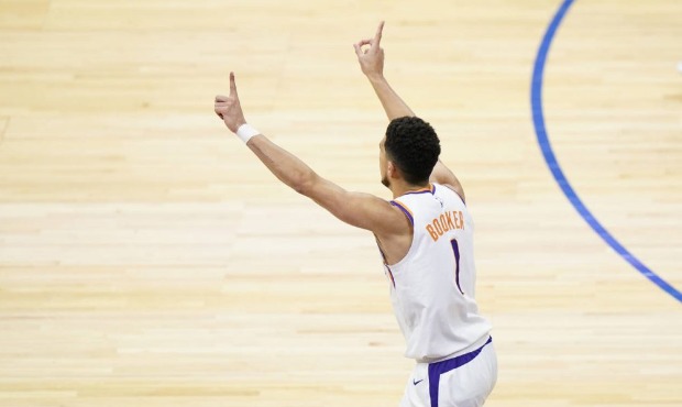 Phoenix Suns' Devin Booker reacts after making a basket during the second half of an NBA basketball...