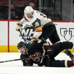 
              Vegas Golden Knights right wing Reilly Smith (19) sends Arizona Coyotes defenseman Ilya Lyubushkin (46) to the ice during the first period of an NHL hockey game Friday, April 30, 2021, in Glendale, Ariz. (AP Photo/Ross D. Franklin)
            