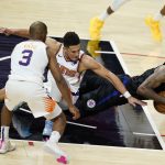 Los Angeles Clippers guard Paul George, right, recovers a loose ball in front of Phoenix Suns guards Devin Booker and Chris Paul during the second half of an NBA basketball game Thursday, April 8, 2021, in Los Angeles. (AP Photo/Marcio Jose Sanchez)