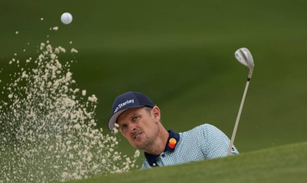 Justin Rose, of England, hits out of a bunker on the seventh hole during the second round of the Ma...