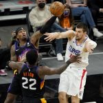 
              Los Angeles Clippers center Ivica Zubac, right, passes over Phoenix Suns center Deandre Ayton (22) during the first half of an NBA basketball game, Wednesday, April 28, 2021, in Phoenix. (AP Photo/Matt York)
            