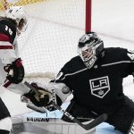 Arizona Coyotes center Christian Dvorak, left, tries to get a shot past Los Angeles Kings goaltender Calvin Petersen during the second period of an NHL hockey game Monday, April 5, 2021, in Los Angeles. (AP Photo/Mark J. Terrill)