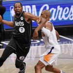 Brooklyn Nets forward Kevin Durant (7) becomes entangled with Phoenix Suns guard Chris Paul during the third quarter of an NBA basketball game, Sunday, April 25, 2021, in New York. (AP Photo/Kathy Willens)