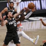 Brooklyn Nets guard Mike James (55) defends Phoenix Suns center Deandre Ayton (22) as Nets guard Landry Shamet (20) looks on from the floor during the second quarter of an NBA basketball game, Sunday, April 25, 2021, in New York. (AP Photo/Kathy Willens)