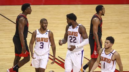 Phoenix Suns guard Chris Paul (3) and center Deandre Ayton (22) talk during a timeout during the fo...