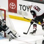 Arizona Coyotes left wing Michael Bunting, center, tires to get a shot past Los Angeles Kings goaltender Calvin Petersen, left, as defenseman Mikey Anderson defends during the first period of an NHL hockey game Monday, April 5, 2021, in Los Angeles. (AP Photo/Mark J. Terrill)