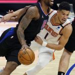 Los Angeles Clippers forward Kawhi Leonard, left, dribbles next to Phoenix Suns guard Devin Booker during the first half of an NBA basketball game Thursday, April 8, 2021, in Los Angeles. (AP Photo/Marcio Jose Sanchez)