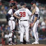 Atlanta Braves pitching coach Rick Kranitz (39) speaks with pitcher Drew Smyly, right, in the first inning of the second baseball game of a double header, against the Arizona Diamondbacks on Sunday, April 25, 2021, in Atlanta. (AP Photo/Ben Margot)