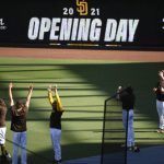 San Diego Padres players warm-up before a baseball game against the Arizona Diamondbacks Thursday, April 1, 2021, on opening day in San Diego. (AP Photo/Denis Poroy)