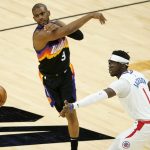 
              Phoenix Suns guard Chris Paul (3) passes as Los Angeles Clippers guard Reggie Jackson (1) defends during the first half of an NBA basketball game, Wednesday, April 28, 2021, in Phoenix. (AP Photo/Matt York)
            