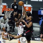 Los Angeles Clippers forward Kawhi Leonard, center right, dunks over Phoenix Suns center Deandre Ayton, center left, during the second half of an NBA basketball game Thursday, April 8, 2021, in Los Angeles. (AP Photo/Marcio Jose Sanchez)