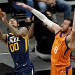 Utah Jazz guard Jordan Clarkson (00) is fouled by Phoenix Suns forward Frank Kaminsky (8) during the second half of an NBA basketball game, Friday, April 30, 2021, in Phoenix. (AP Photo/Matt York)