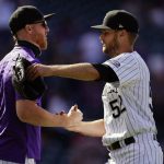 Colorado Rockies starting pitcher Jon Gray, left, congratulates relief pitcher Daniel Bard after he retired the final two batters from the Arizona Diamondbacks in the ninth inning of a baseball game Thursday, April 8, 2021, in Denver. The Rockies won 7-3. (AP Photo/David Zalubowski)