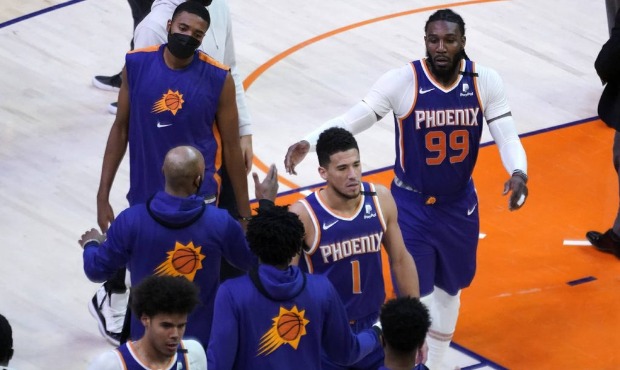 Phoenix Suns guard Devin Booker (1) and forward Jae Crowder (99) celebrate during a time out during...