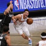 Phoenix Suns guard Devin Booker (1) reacts as Brooklyn Nets guard Mike James (55) collides with him as Booker drives to the basket during the first quarter of an NBA basketball game, Sunday, April 25, 2021, in New York. (AP Photo/Kathy Willens)