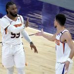 Phoenix Suns forward Jae Crowder (99) celebrates his three pointer with guard Devin Booker during the first half of an NBA basketball game against the Houston Rockets, Monday, April 12, 2021, in Phoenix. (AP Photo/Matt York)