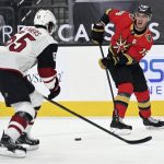 Vegas Golden Knights right wing Reilly Smith (19) looks to the puck against Arizona Coyotes defenseman Jason Demers (55) during the second period of an NHL hockey game Friday, April 9, 2021, in Las Vegas. (AP Photo/David Becker)