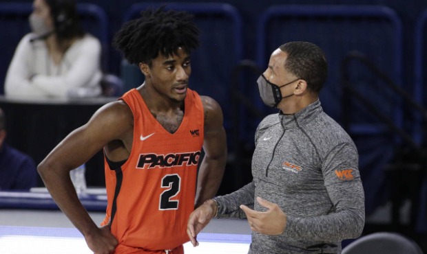Pacific coach Damon Stoudamire, right, speaks with guard Jalen Brown during the second half of the ...