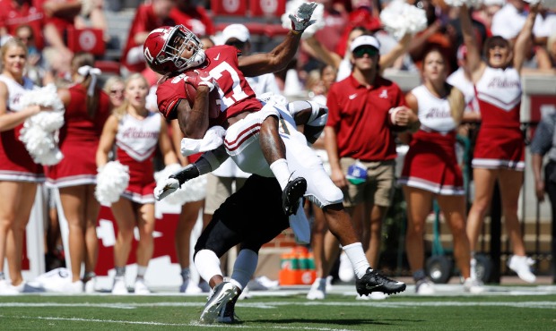 Jaylen Waddle #17 of the Alabama Crimson Tide gets tackled after catching a pass in the second quar...