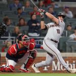 Josh Rojas #10 of the Arizona Diamondbacks hits a RBI double in the seventh inning against the Atlanta Braves at Truist Park on April 23, 2021 in Atlanta, Georgia. (Photo by Kevin C. Cox/Getty Images)