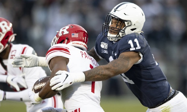 In this Nov. 30, 2019, file photo, Penn State linebacker Micah Parsons (11) tackles Rutgers tight e...